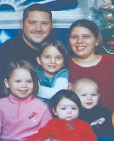 A family photo of Summer Garas, 25, back right, and her four children, from the left; Autumn Rust 6, Kirsten Rust, 7, Evynn Garas, 3, and  Teagin Rust, 4,  is seen in El Reno, Okla. on Tuesday, Jan. 13, 2009.  Garas and her four young children were found dead in their central O=klahoma apartment Monday, and authorities Tuesday were searching for her 25-year-old boyfriend as the suspect. The man in photo is not identified. (AP Photo/Alonzo Adams via Garas family)