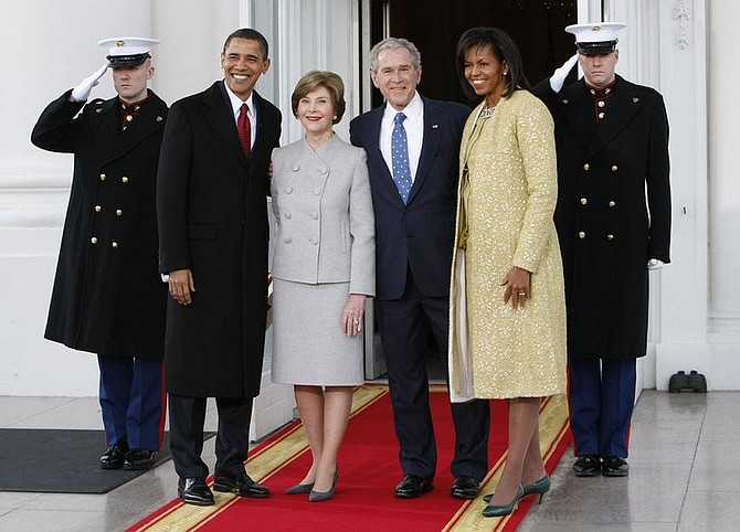 President Bush, center right, and first lady Laura Bush, center left, welcome President-elect Barack Obama, far left, and his wife Michelle Obama, right, on the North Portico of the White House in Washington, Tuesday, Jan. 20, 2009.(AP Photo/Pablo Martinez Monsivais)