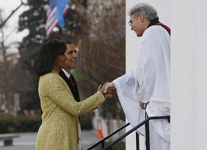 President-elect Barack Obama and Michelle Obama are welcomed by Rev. Luis Leon as they arrive for  church service at St. John&#039;s Episcopal Church across from the White House in Washington, Tuesday, Jan. 20, 2009. (AP Photo/Charles Dharapak)