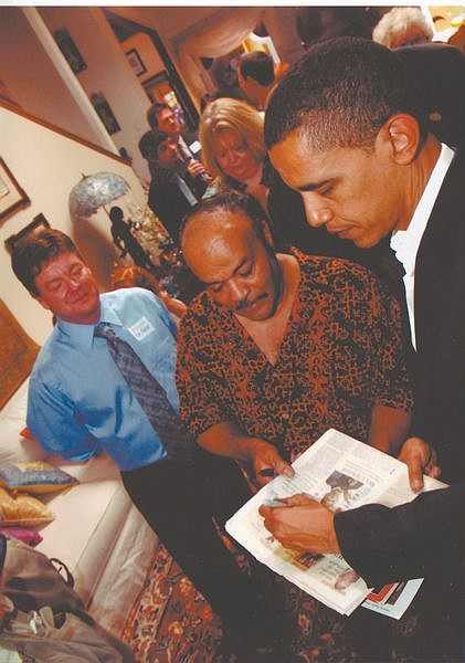 Courtesy photoBarack Obama signs a newspaper for Charles Adams while campaigning in Carson City in June 2007.