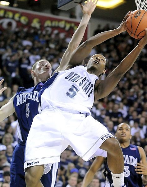 Utah State guard Pooh Williams drives to the basket as Nevada forward Luke Babbitt defends during an NCAA college basketball game Thursday, Jan. 29, 2009, in Logan, Utah. (AP Photo/The Herald Journal, Eli Lucero)