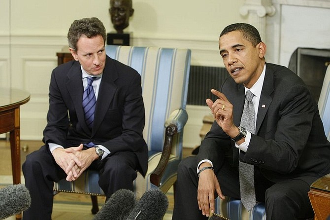 President Barack Obama speaks about the economy as Treasury Secretary Tim Geithner looks on in the Oval Office of the White House in Washington, Thursday, Jan. 29, 2009. (AP Photo/Charles Dharapak)