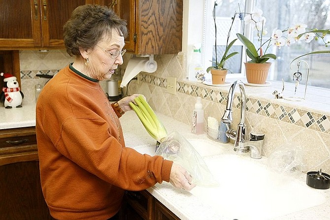 Shannon Litz/Nevada Appeal News ServiceGardnerville resident Sue Bennett prepares to wash some celery at her home Thursday. She became ill with salmonella after eating packaged peanut butter crackers. Since Sept. 1, 500 people have  contracted salmonella &quot; including Bennett.