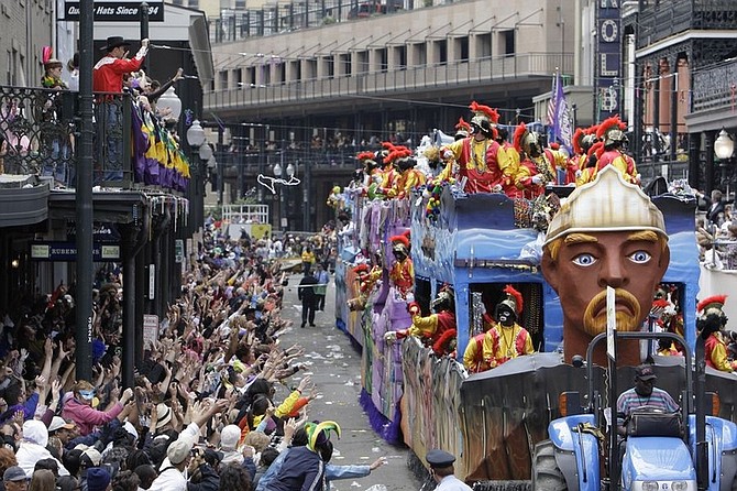 Revelers throw and catch beads as the Zulu parade rolls down St. Charles Avenue on Mardi Gras in New Orleans Tuesday, Feb. 24, 2009. Carnival revelers were greeted with clear weather for Mardi Gras. (AP Photo/Alex Brandon)