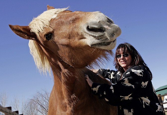 Jill Starr, president of Lifesavers Wild Horse Rescue in Lancaster, Calif., pats Arrow, who was saved from slaughter. She said she often has to deny requests for help from horse owners because of increased expenses and fewer donations. Illustrates HORSES (category a) by Ann M. Simmons (c) 2009, Los Angeles Times. Moved Thursday, March 5, 2009. (MUST CREDIT: Los Angeles Times photo by Anne Cusack.)