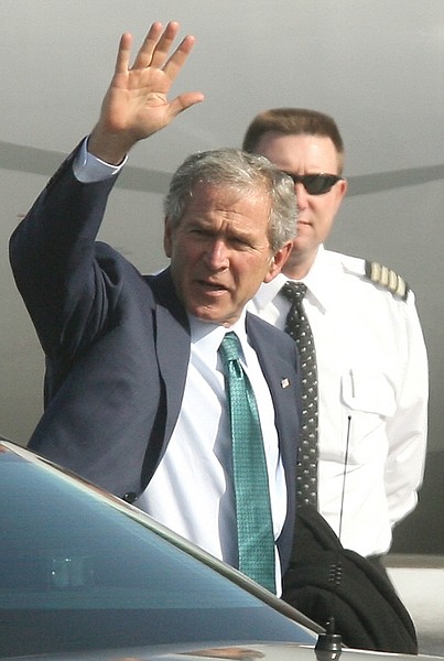 Former U.S. President George W. Bush waves as he boards a plane leaving Calgary, Canada, Tuesday, March 17, 2009  following a speaking engagement. (AP  Photo/Jim Wells, Calgary Sun via The Canadian Press)