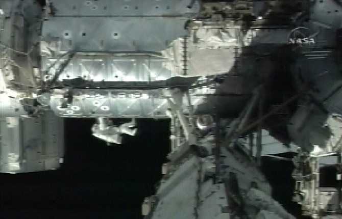 In this image from NASA TV, space shuttle Discovery crew member Steven Swanson works outside the international space station during a space walk orbiting Earth, Saturday, March 21, 2009. This is the second spacewalk during shuttle Discovery&#039;s mission. (AP Photo/NASA TV)