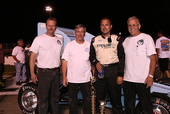 Rhonda Costa/For the Nevada AppealTroy Regier (in driver&#039;s suit) with S&amp;S Motorsports team, from left, John Stewart, and co-owners Tom Silsby and Steve Shaw in Winner&#039;s Circle after the 38th annual Vukovich Classic race at Madera Speedway Saturday. Not pictured, Mike Burts.