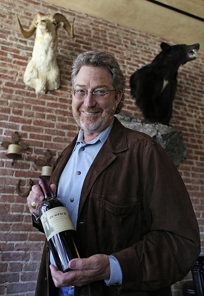 **FOR USE WITH AP LIFESTYLES**  In this photo take Friday April 24, 2009, Mark Pope poses with a bottle of wine he sells at his wine shop and restaurant in Napa, Calif. &quot;The so-called cult wines are not quite as elusive as they were,&quot; says Pope, founder and CEO of the Bounty Hunter, a Napa shop carrying wines that range from $10 to hundreds of dollars a bottle. &quot;It&#039;s a lot more competitive world than it was.&quot;(AP Photo/Eric Risberg)