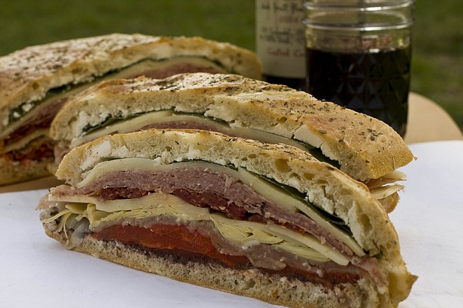 **FOR USE WITH AP LIFESTYLES** An Overnight Brick Sandwich is seen in this Sunday April 19,2009 photo. A wonderful collection of flavors and juices blend together in this Overnight Brick Sandwich. The sandwich, perfect for a picnic, gets its name from its preparation where it spends the night refrigerated under the weight of a brick, with the result of a dense, flavor packed meal. (AP Photo/Larry Crowe)