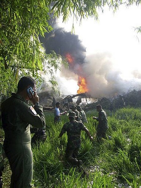 Indonesian air force personnel rush to the site where a military C-130 cargo plane crashed in Magetan, East Java, Indonesia, Wednesday, May 20, 2009. The plane carrying more than 100 people crashed and burst into flames Wednesday, killing at least 68 people, officials said. (AP Photo/detikSurabaya.com) ** MANDATORY CREDIT **