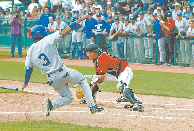 PHOTO BY CHRISTOPHER TOMLINSON--#3, Mike Long from Western Nevada College slides safe into home plate under the tag of Howard College catcher #21, Monk Kreder for the first run of the game.Sent as JUCO DAY 1 3.