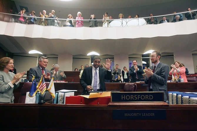 Senate Majority Leader Steven Horsford, D-Las Vegas, center, waves after receiving a gift from Sen. Terry Care, D-Las Vegas, in the Senate Chambers at the Nevada Legislature around 8:50 p.m., in Carson City, Nev.