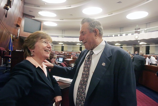 Speaker of the Assembly Barbara Buckley, D-Las Vegas, left, and Assemblyman John Carpenter, R-Elko, celebrate the end of the session in the Assembly Chambers on Monday.