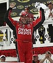 Tony Stewart celebrates in victory lane at Pocono Raceway in Long Pond, Pa., after winning the NASCAR Pocono 500 auto race Sunday, June 7, 2009. (AP Photo/Russ Hamilton Sr.)