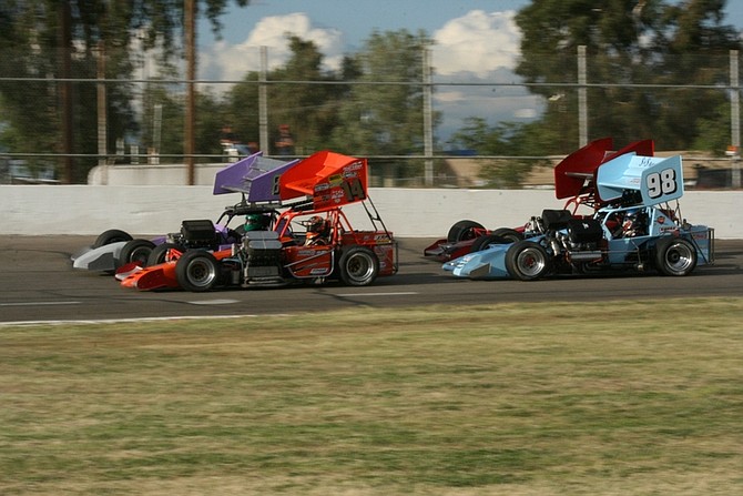 RHONDA COSTA/For the Nevada AppealTroy Regier, No 98, runs against three other cars during a heat race Saturday at Madera Speedway in Madera, Calif.