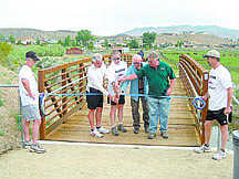 Jeff Moser/Submitted photoMayor Bob Crowell and members of the Carson City Open Space Committee cut the ribbon to ceremoniously open the bridges on the Mexican Ditch Trail on Saturday.