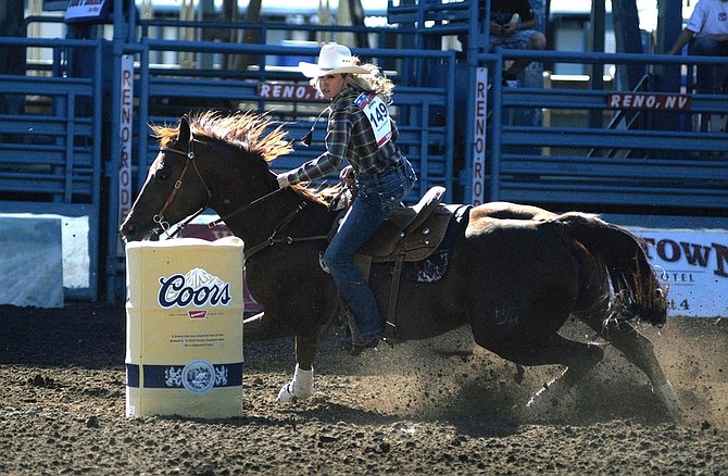 Carmen Creekbaum turns her horse around a barrel as she competes in barrel racing at the Reno Rodeo on Friday, June 19, 2009 in Reno, Nev.