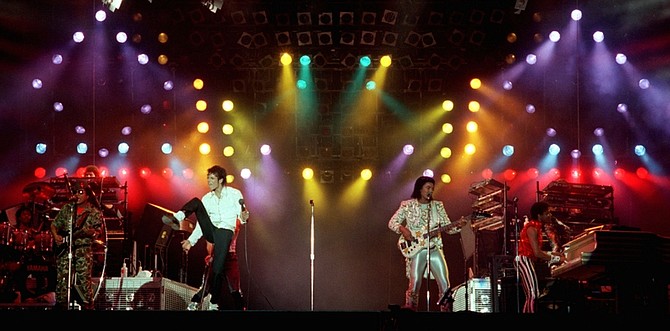 In this Dec. 3, 1984 photo, Michael Jackson, center left, performs with his brothers at Dodger Stadium in Los Angeles as part of their Victory Tour concert. Jackson, the sensationally gifted child star who rose to become the &quot;King of Pop&quot; and the biggest celebrity in the world only to fall from his throne in a freakish series of scandals, died Thursday. He was 50. (AP Photo/Doug Pizac)