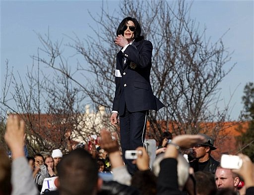 FILE - In this Friday, Jan. 16, 2004 file picture, Michael Jackson waves to his fans from atop his limousine after his arraignment on child molestation charges at the courthouse in Santa Maria, Calif. Jackson has died in Los Angeles at the age of 50 on Thursday, June 25, 2009. (AP Photo/Nick Ut)