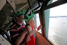 **ADDS POOL PHOTO DESIGNATION**Chris Bartnick, 46, left, hoists his daughter Aleyna, 8, both of Merrick, N.Y., for a better view from the crown of the Statue of Liberty in New York, Saturday July 4, 2009. The first visitors were allowed into the Statue of Liberty&#039;s crown Saturday in nearly eight years after it was closed to the public after the Sept. 11, 2001, attacks. The base, pedestal and outdoor observation deck were reopened in 2004, but the crown remained off-limits. (AP Photos/David Goldman, pool)