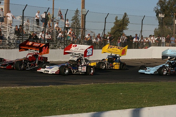Rhonda Costa/For the Nevada AppealKenny White, 26, Bryan Warf, 91, Troy Regier and George Greenway, 8x, on the first lap of the second heat race at Madera Speedway. Regier finished second.