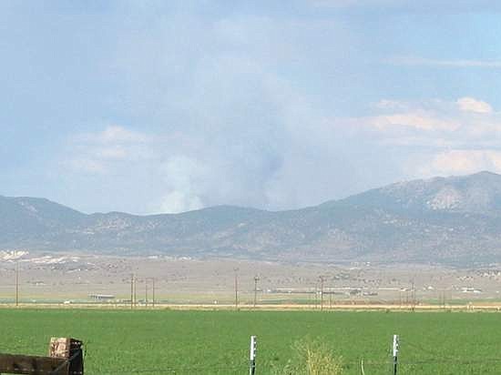 Kurt Hildebrand/Record-CourierSmoke rises over the Pine Nuts Friday afternoon. The fire is holding at about 50 acres.