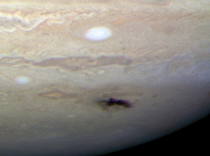 This image provided by NASA&#039;s Hubble Space Telescope taken with it&#039;s Wide Field Camera 3 on Thursday July 23, 2009 shows the sharpest visible-light picture taken of the impact feature (dark spot) and &quot;backsplash&quot; of material from a small object that plunged into Jupiter&#039;s atmosphere and disintegrated. The only other time in history such a feature has been seen on Jupiter was in 1994 during the collision of fragments from comet Shoemaker-Levy 9. This is a natural color image of Jupiter as seen in visible light. (AP Photo/NASA)