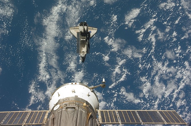 This image provided by NASA shows the space shuttle Endeavour backdropped by a blue and white Earth, taken by a member of the Expedition 20 crew onboard the International Space Station shortly after the shuttle and station began their post-undocking separation on Tuesday July 28, 2009. (AP photo/NASA)