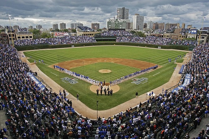 FILE - In this Oct. 1, 2008, file photo, the Chicago Cubs and the Los Angeles Dodgers line up at Wrigley Field before Game 1 of baseball&#039;s National League division series in Chicago. Tribune Co. has reached a long-awaited definitive agreement Friday, Aug. 21, 2009, to sell the Chicago Cubs and Wrigley Field to the billionaire Ricketts family. (AP Photo/Charles Rex Arbogast, File)
