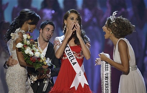 Miss Venezuela Stefania Fernandez, center, reacts as she is named Miss Universe 2009 next to Miss Universe 2008 Dayana Mendoza, also of Venezuela, right, at the end the Miss Universe beauty pageant in Nassau, Bahamas, Sunday, Aug. 23, 2009. Miss Dominican Republic Ada Aimee De la Cruz, left, was first runner up. (AP Photo/Andres Leighton)