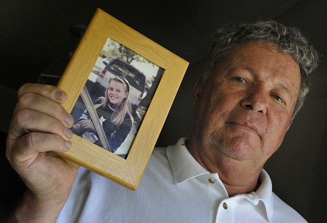 In this photo taken Aug. 27, 2009, William Carl Probyn holds a photograph of his step daughter Jaycee Lee Dugard in Anaheim, Calif. A woman walked in into a San Francisco Bay area police station Wednesday, Aug. 27, 2009, saying she was Jaycee Lee Dugard, a blond, pony tailed girl when she was abducted as she headed to a school bus stop 18 years ago, said sheriff&#039;s Lt. Les Lovell of the El Dorado Sheriff&#039;s Department.(AP Photo/Orange County Register, Bruce Chambers)