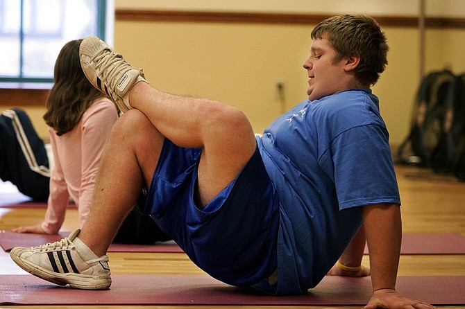 Published Caption: Ray Crawford, 16, of Windber, Pa., participates in an aerobics class for children and teenagers at the Windber Medical Center in Windber, Pa., Feb. 10, 2005. In the community of Windber and in rural towns across the nation, the percentage of overweight children has soared and childhood obesity is increasing at an alarming rate, health officials say.