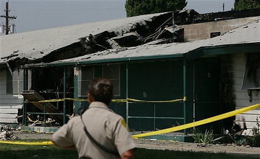 A correctional officer looks over the damage  of a prison room destroyed from a riot last week at the California Institution for Men Wednesday, August 19, 2009 in Chino, Calif.. Gov. Arnold Schwarzenegger on Wednesday toured the Southern California prison where 175 inmates were injured in a riot earlier this month, likening the devasation to a scene from one of his movies. (AP Photo/The Press-Enterprise, Stan Lim) ** NO SALES; MAGS OUT; MANDATORY CREDIT **