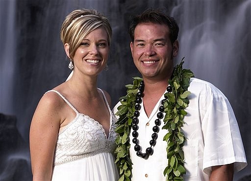 FILE-In this  file publicity image released by TLC, reality TV stars, Jon Gosselin, right, and his wife Kate Gosselin, from the TLC series, &quot;Jon &amp; Kate Plus 8,&quot; are shown in Hawaii. Celebrity mom Kate Gosselin  said Monday, Aug. 10, 2009, that she still wears her wedding ring for her eight children, but feels a lot of failure that the marriage is over. (AP Photo/TLC, Mark Arbeit) ** NO SALES **