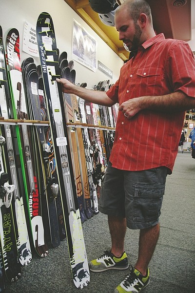 Annie Flanzraich/Nevada Appeal News ServiceVillage Ski Loft Manager Ben Fresco examines a pair of skis before shopping for the winter season begins.