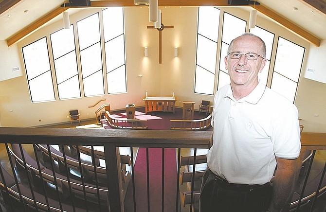 Shannon Litz/Nevada Appeal News ServicePastor Norm Milz at Shepherd of the Sierra Lutheran Church poses inside the sanctuary of the new church Sept. 3.