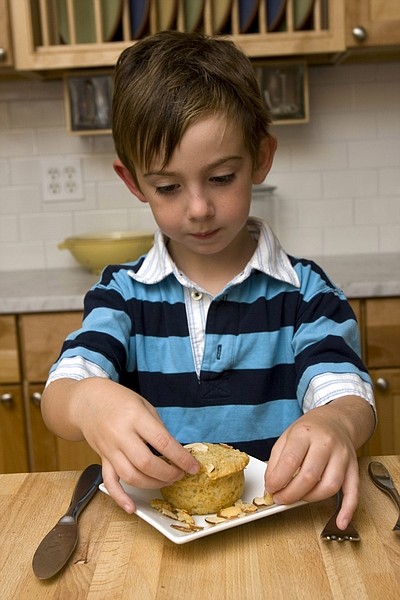 This photo taken Sept. 22, 2009 shows Parker Hirsch trying out a Parsnip muffin. Several of the celebrity chefs from the Food Network were challenged to entice a vegetable averse child eat his veggies. Hirsch, 5, of Concord, N.H. found Alton Brown&#039;s Parsnip Muffins the winner in the taste test, although the almonds had to go. (AP Photo/Larry Crowe)