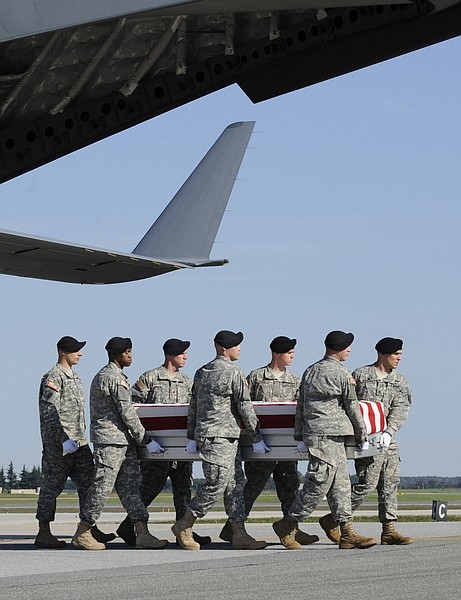 A carry team carries the transfer case containing the remains of Army Spc. Christopher T. Griffin of Kincheloe, Mich., who died in Operation Enduring Freedom, Tuesday, Oct. 6, 2009, during the dignified transfer event at Dover Air Force Base in Dover, Del. (AP Photo/Susan Walsh)