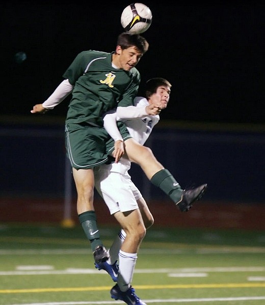Brad Horn/For the Nevada AppealCarson&#039;s Ian Gunn battles with a Manogue defender for the ball Wednesday at Carson High School.