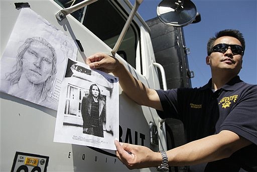 Jimmy Lee of the Contra Costa County Sheriff&#039;s office holds up a copy of Phillip Garrido taken after an arrest in Reno, Nev., alongside a sketch of a man believed to have kidnapped Michaela Garecht, outside Garrido&#039;s home in Antioch, Calif., Tuesday, Sept. 15, 2009. Police investigating two child abductions in the 1980s searched the Northern California home of a man charged with kidnapping a girl and holding her captive for 18 years. The Hayward and Dublin police departments went through Phillip Garrido&#039;s Antioch property and a site next door on Tuesday, seeking evidence in the disappearances of Michaela Garecht in 1988 and Ilene Mischeloff in 1989, authorities said. (AP Photo/Eric Risberg)