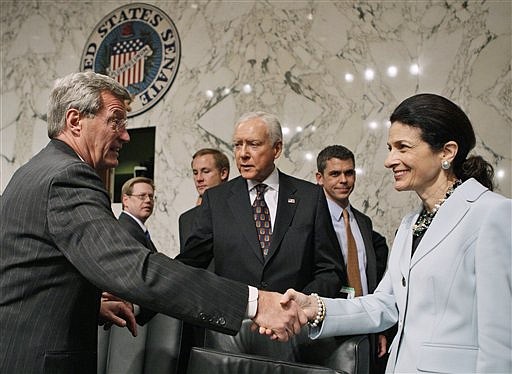 Senate Finance Committee Chairman Sen. Max Baucus, D-Mont., left, shakes hands with committee member Sen. Olympia Snowe, R-Maine, as Sen. Orrin Hatch, R-Utah, is seen at center, Tuesday, Oct. 13, 2009, on Capitol Hill in Washington, after a committee vote regarding the health care reform bill.  (AP Photo/Charles Dharapak)