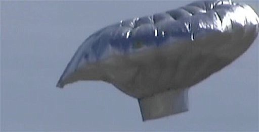 In this image rendered from video and released by KMGH-TV in Denver, a hot-air balloon is seen over Colorado, near Fort Collins. A 6-year-old boy climbed into a hot-air balloon aircraft and floated away Thursday, forcing officials to scramble to figure out how to rescue the boy. Larimer County sheriff&#039;s spokeswoman Eloise Campanella says the device, which is shaped like a flying saucer, has the potential to rise to 10,000 feet. (AP Photo/KMGH-TV ) MANDATORY CREDIT; NO SALES