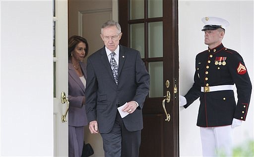FILE -  In this Sept. 8, 2009 file photo, Senate Majority Leader Harry Reid, of Nev., center, followed by House Speaker Nancy Pelosi, of Calif., walks out of the West Wing of the White House in Washington to speak to reporters after talking with President Barack Obama about health care. With the Senate Finance Committee on the verge of approving a sweeping health overhaul bill Tuesday, Oct. 6, 2009, the path might appear open for action by the full Senate. But Reid has a tough task ahead in finalizing the health care bill. (AP Photo/Charles Dharapak, File)