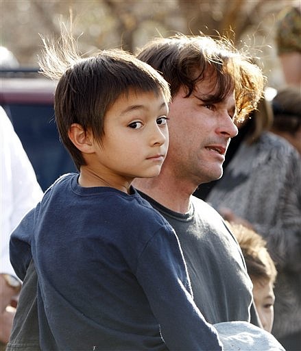 FILE - In this Oct. 15, 2009 file photo, six-year-old Falcon Heene is shown with his father, Richard, outside the family&#039;s home in Fort Collins, Colo., after Falcon Heene was found hiding in a box in a space above the garage. The attorney for the Colorado father who reported his son floated away in a helium balloon says, Thursday, Nov. 12, 2009,  his client and the boy&#039;s mother will both plead guilty to charges in the case. (AP Photo/David Zalubowski, File)