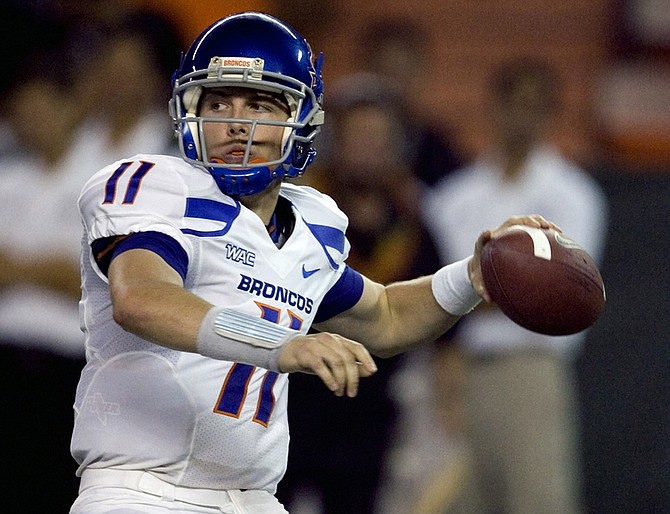 FILE - In this Oct. 24, 2009, file photo, Boise State quarterback Kellen Moore throws a pass during the second quarter of an NCAA college football game against Hawaii in Honolulu. Boise State plays Nevada on Friday night with the WAC title on the line. (AP Photo/Marco Garcia)