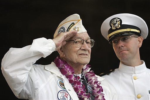 Pearl Harbor survivor Arthur G. Herriford, left, salutes while U.S. Navy Lt. Ben Abney looks on during the ceremony marking the 68th anniversary of the attack at Pearl Harbor, Monday, Dec. 7, 2009 at Pearl Harbor Naval Base in Honolulu.  Herriford served aboard the USS Detroit during the surprise attack in 1941.  AP Photo/Marco Garcia)