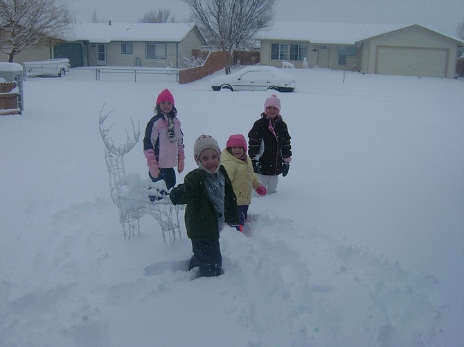 Submitted by Staci KlingFrom left to right, Aubri, Grant, Avah and Alexis Kling take advantage of Monday&#039;s snow day, playing in the yard of their Mark Twain home. Lyon County schools will remain closed Tuesday.