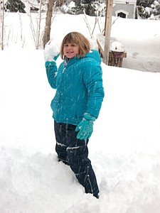 Emily HowarthOksana White prepares to lob a large snowball into the camera while playing in the snow Monday morning at home on the westside of Carson City.