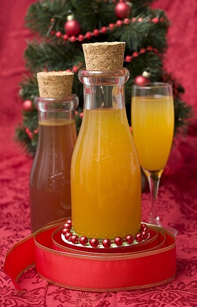 This photo taken Nov. 22, 22009 shows a apricot--ginger fizz mixer. Cocktail mixers apricot-ginger fizz mixer, foreground and cranberry cocktail mixer, left, are inexpensive gifts that have style. (AP Photo/Larry Crowe)